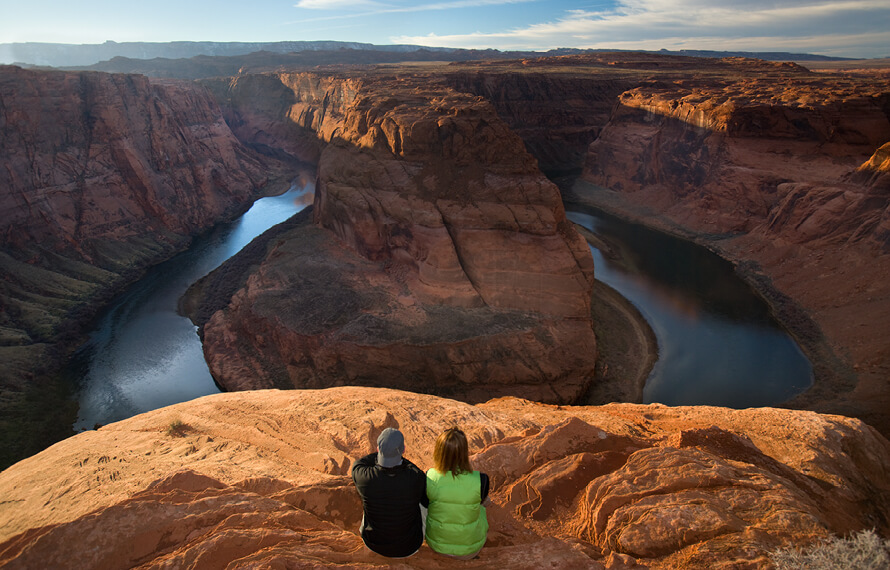 People sitting on rock cliff