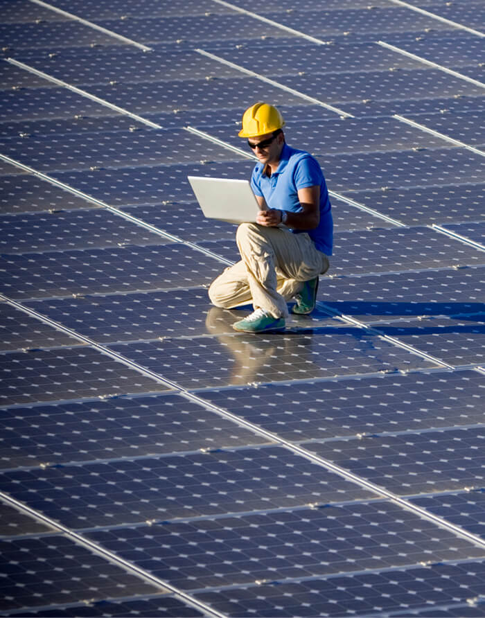 Man checking solar panels