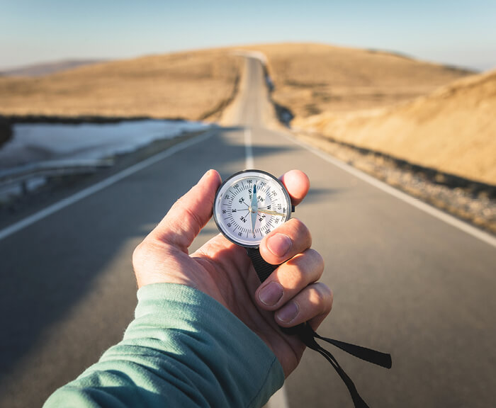 Hand holding compass